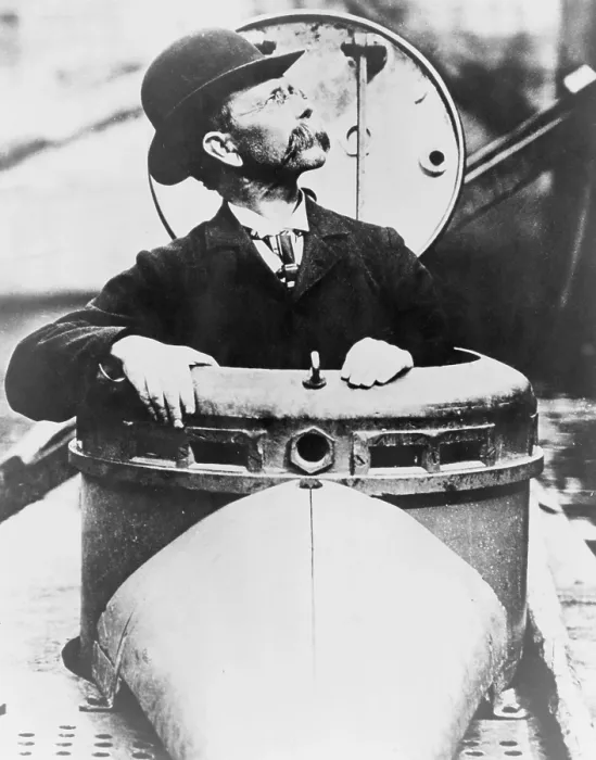 Framed Print : John P. Holland (1841-1914), climbing up hatch of his invention, the USS Holland submarine, the US Navy's first commissioned submarine. Ca. 1900