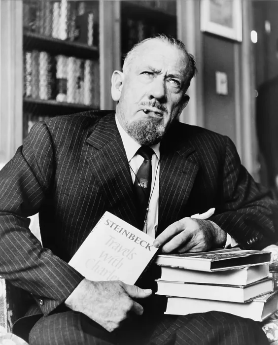 Framed Print : John Steinbeck (1902-1968), American author who received the Nobel Prize in 1962, holds his most recent book 'Travels with Charley.' 1962