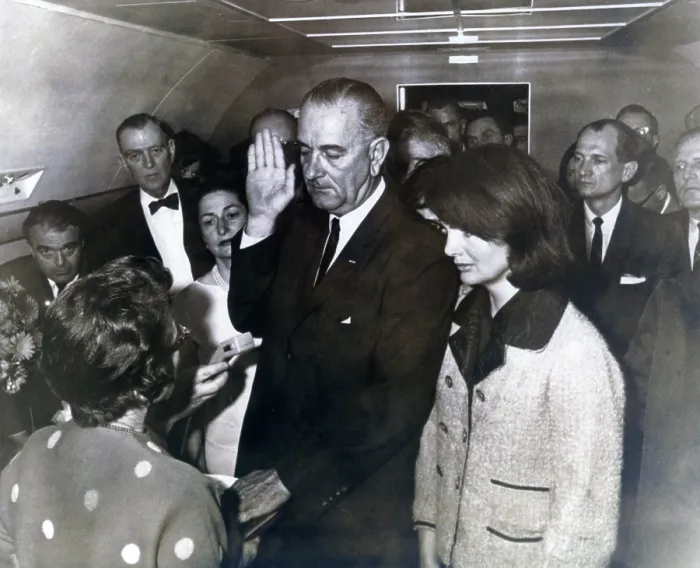 Framed Print : Johnson taking oath. Ladybird Johnson and former first lady Jacqueline Kennedy witness U.S. District Judge Sarah T. Hughes administering the oath of office to Lyndon B