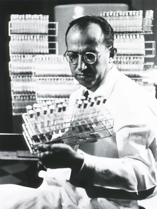 Framed Print : Jonas E. Salk (1914-1995), American medical researcher who developed the first Polio vaccine, holding tray of test tubes. Ca. 1955