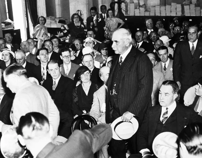 Framed Print : J.P. Morgan Jr. arriving to testify to the Senate Banking and Currency Committee. May 23, 1933. Witnesses and Senators are seated in the Caucus Room of the Senate Office Building
