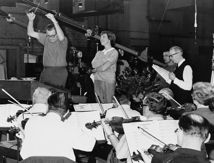 Framed Print : Julie Andrews singing with an orchestra in a recording studio for sound track of film, THE SOUND OF MUSIC (1964)
