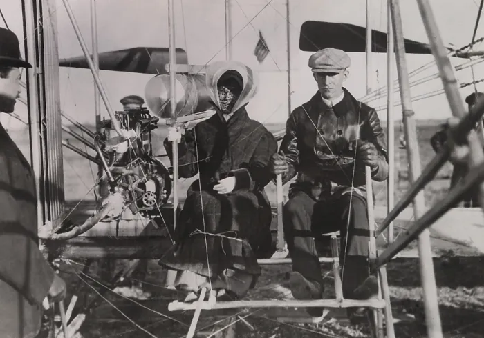 Framed Print : Katharine Wright sits beside brother Wilber at the beginning of her first ride in an airplane. Photo was taken in southern France on Feb. 15, 1909