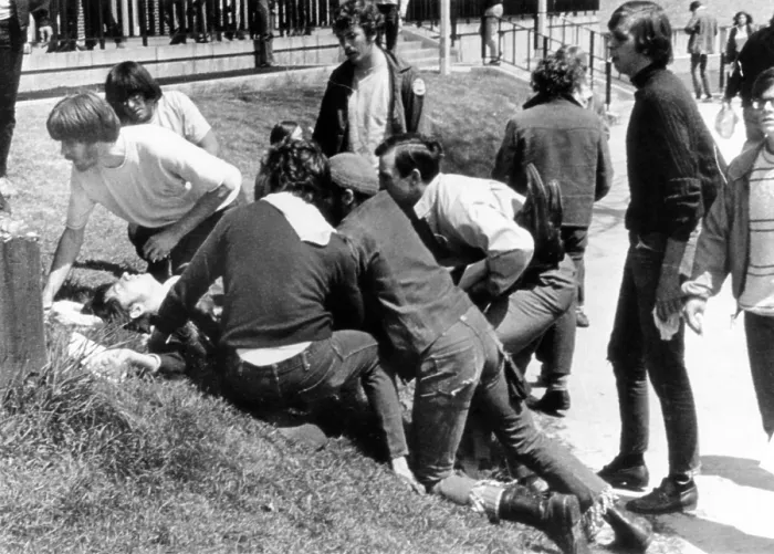 Framed Print : Kent State University students come to the aid of a wounded youth