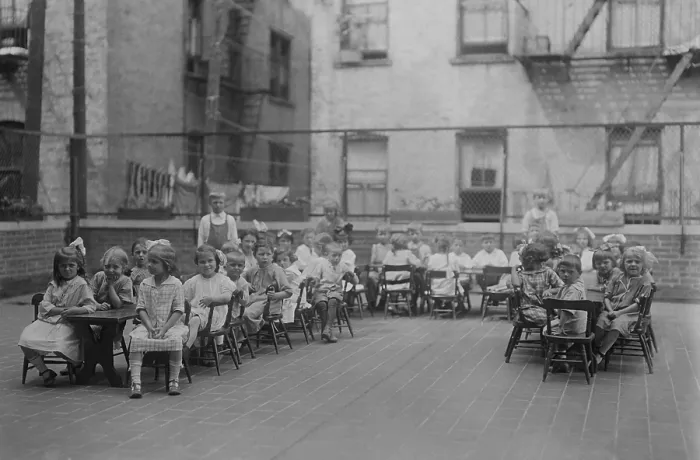 Framed Print : Kindergarten children sit in chairs at long tables on the roof of the Lenox Hill Settlement House, c. 1915-20. (BSLOC_2018_1_155) Framed Print : Kindergarten children sit in chairs at long tables on the roof of the Lenox Hill Settlement House, c. 1915-20. (BSLOC_2018_1_155)