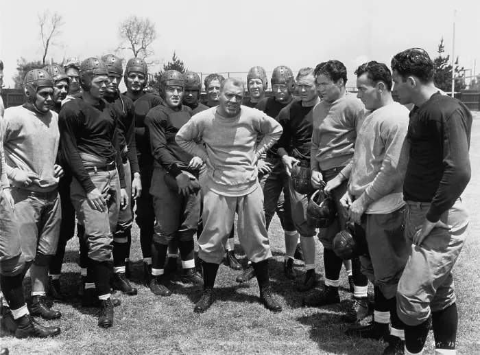 Framed Print : KNUTE ROCKNE ALL AMERICAN, center with hands on waist: Pat O'Brien, 1940