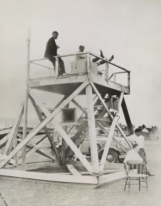 Framed Print : Knute Rockne, seated on coaching tower, as he overlooks the football field at South Bend. Rockne directs the action through the advanced technology of loud speakers