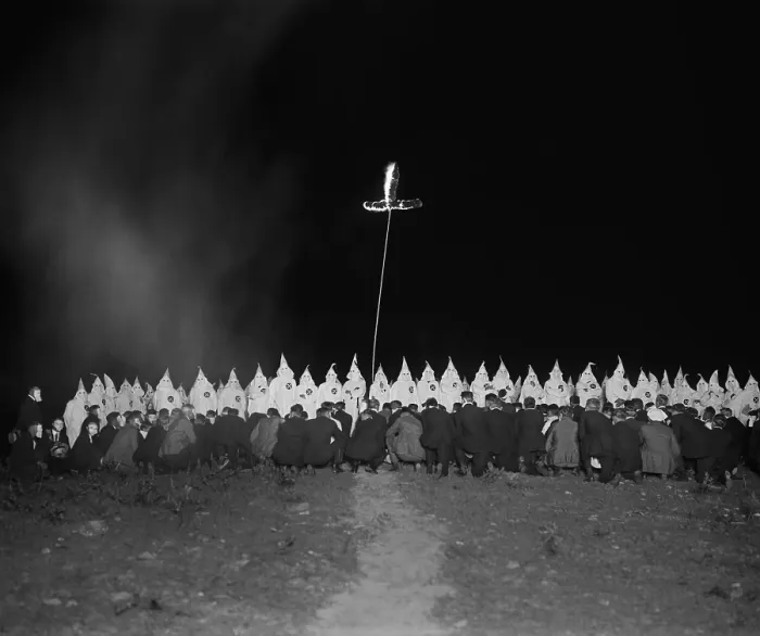 Framed Print : Ku Klux Klan gathering with fully robed and hooded members and kneeling men in face masks Framed Print : Ku Klux Klan gathering with fully robed and hooded members and kneeling men in face masks