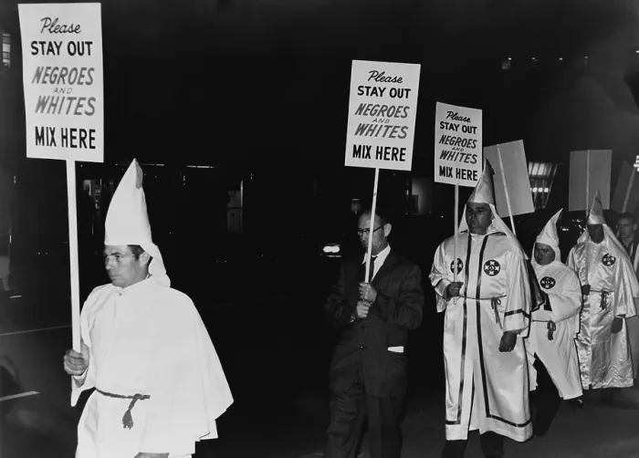 Framed Print : Ku Klux Klan members, in hooded white robes hoods, picket an integrated business carrying placards stating, Please stay out, Negroes and Whites mix here'. 1964 Framed Print : Ku Klux Klan members, in hooded white robes hoods, picket an integrated business carrying placards stating, Please stay out, Negroes and Whites mix here'. 1964