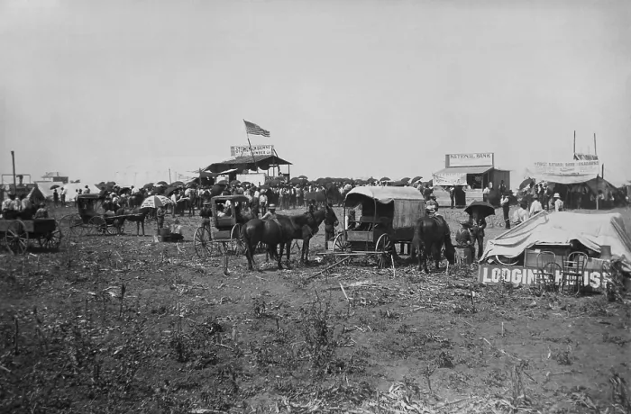 Framed Print : Land auction in progress at the lumber company booth, with banks offering their services at right