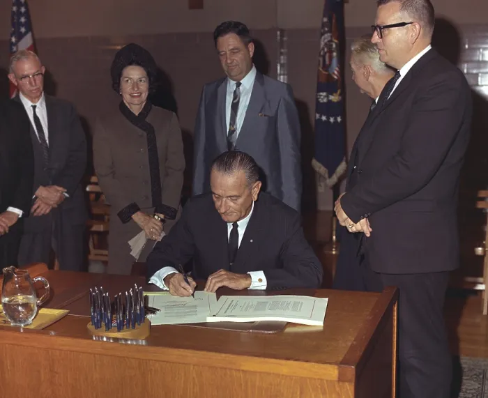Framed Print : LBJ's Great Society programs. President Lyndon Johnson signing of the Higher Education Act of 1965 at Southwest Texas State College, where he attended college in the 1920s