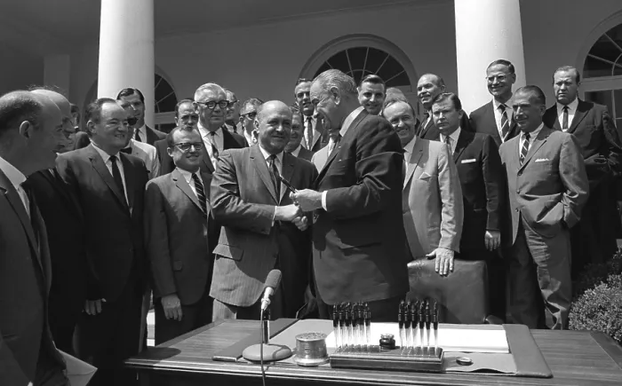 Framed Print : LBJ's Great Society programs. President Lyndon Johnson shakes HUD Secretary, Robert Weaver, after signing of the Housing and Urban Development Act