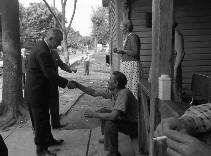 Framed Print : LBJ's War on Poverty. President Lyndon Johnson shakes hands with an Appalachian resident. May 7, 1964