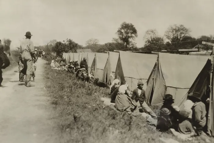Framed Print : Levee at Greenville, Mississippi, where African Americans sit by tents on uneven ground. The tents were supplied by the American Red Cross