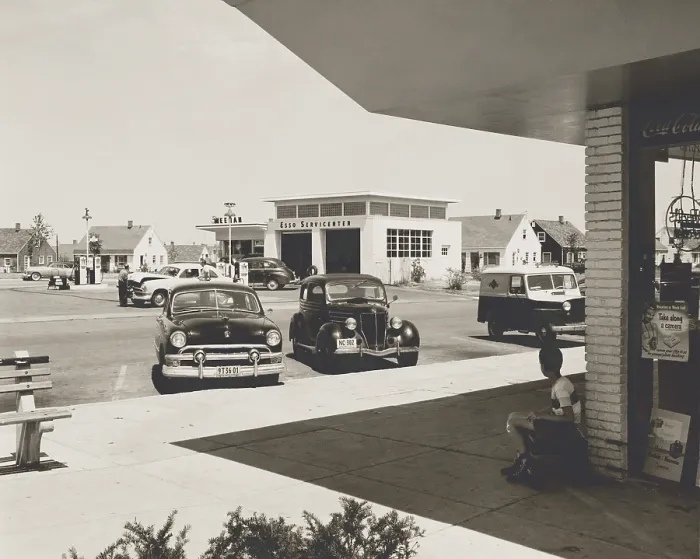Framed Print : Levittown, N.Y. corner store across the street from a gas station. It was the first mass-produced suburb and had common public amenities such as community centers and stores. Aug