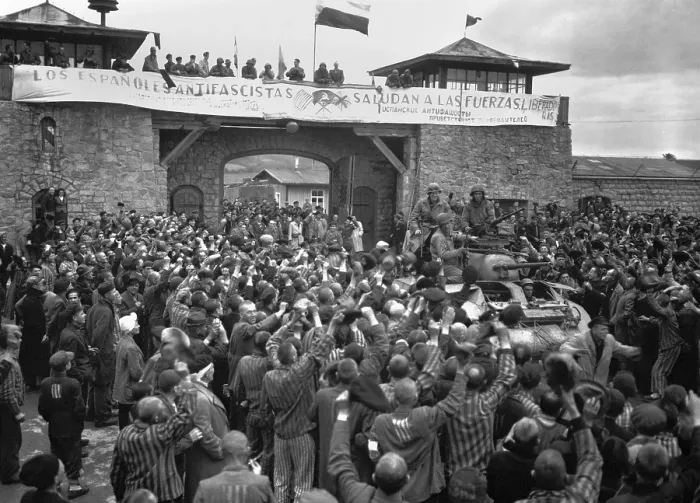 Framed Print : Liberated prisoners in the Mauthausen concentration camp cheer U.S. soldiers. The banner across the wall was made by Spanish Loyalist prisoners. The U.S