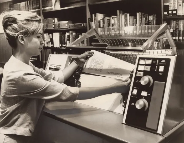 Framed Print : Librarian taking a printout from a UNIVAC 490 Printer. In the 1960s computer technology was available for specialists in this case to manage library catalogs and book circulation