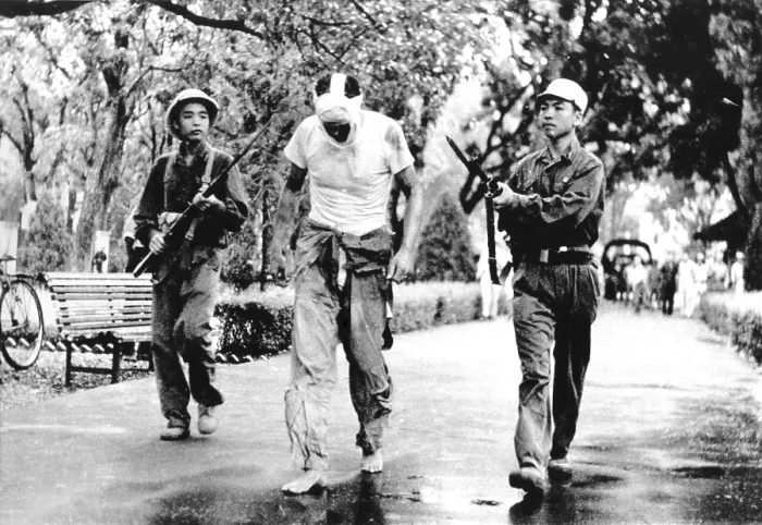 Framed Print : Lieut. Col. James Lindberg Hughes, American F-105 Pilot under guard by North Vietnamese soldiers. May 6, 1967