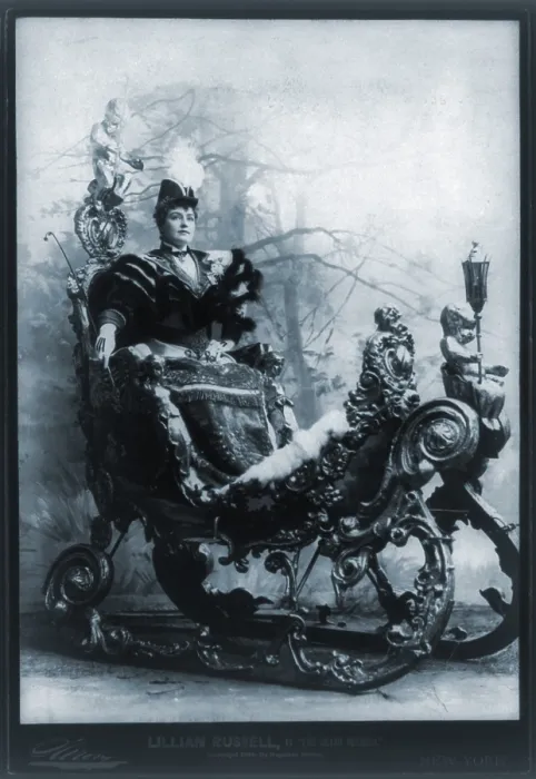 Framed Print : Lillian Russell (1861-1922), American actress, seated in ornate sleigh, in THE GRAND DUTCHESS. 1894 Framed Print : Lillian Russell (1861-1922), American actress, seated in ornate sleigh, in THE GRAND DUTCHESS. 1894