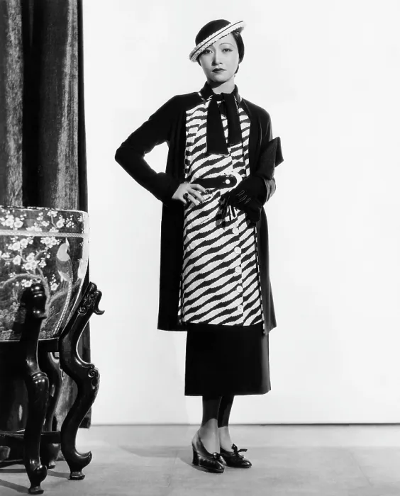 Framed Print : LIMEHOUSE BLUES, (aka EAST END CHANT), Anna May Wong, in a navy-and-white silk suit and straw hat, 1934