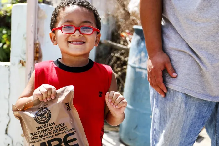 Framed Print : A little boy with army rations distributed in San Juan, Puerto Rico, after Hurricane Maria. The storm struck the island on Sept Framed Print : A little boy with army rations distributed in San Juan, Puerto Rico, after Hurricane Maria. The storm struck the island on Sept