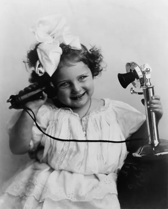 Framed Print : Little girl talking on an early model telephone. Ca. 1905 Framed Print : Little girl talking on an early model telephone. Ca. 1905