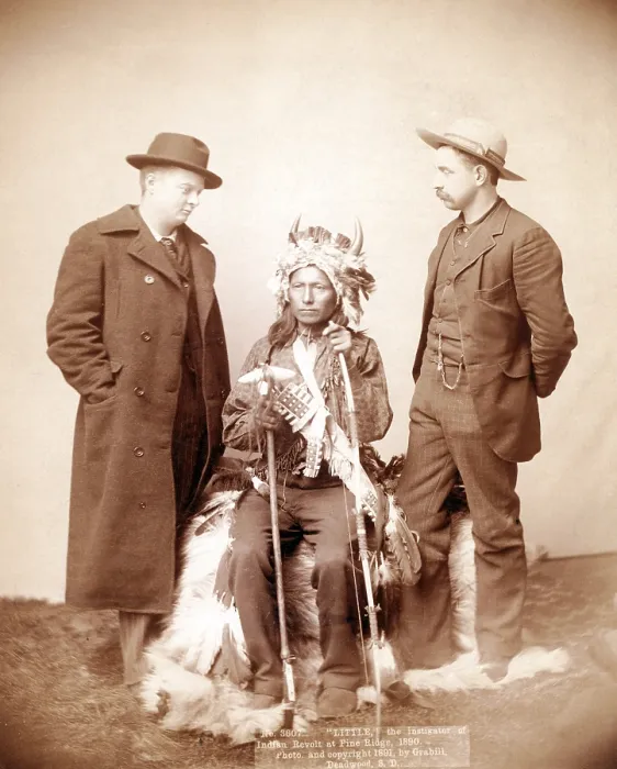 Framed Print : Little, Oglala band leader, full-length studio portrait seated between two men who are standing on either side of him, photograph by John C. H. Grabill, 1891