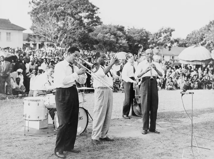 Framed Print : Louis Armstrong (1901-1971), African American Jazz musician, playing trumpet with band at an outdoor gathering in Africa, 1956