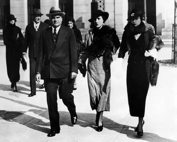 Framed Print : Louis Froelich, attorney for the Vanderbilt family (front left), and Gloria Morgan Vanderbilt (right), leaving the custody hearing of Gloria Laura Vanderbilt, circa July 25, 1934