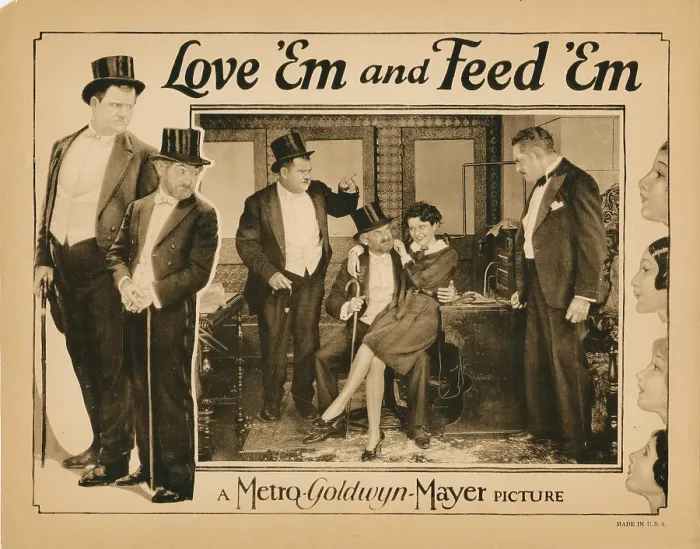 Framed Print : LOVE EM AND FEED EM, lobbycard, Oliver Hardy (left, and pointing), Max Davidson (beard), Viola Richard (sitting on lap), 1927