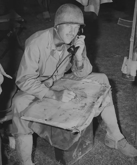 Framed Print : Lt. Col. Raymond Murray taking a message over field phone and plotting positions on a map, August 23, 1950