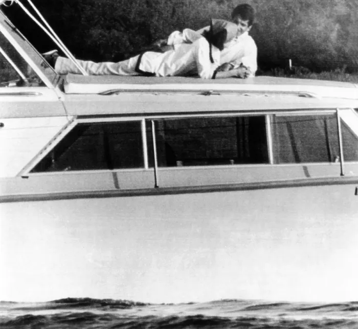 Framed Print : Lynda Bird Johnson relaxes on her father's cabin cruiser with her weekend guest, actor George Hamilton