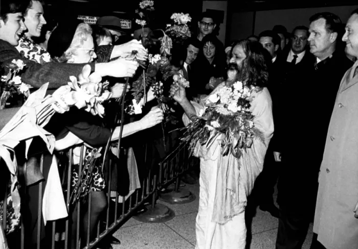 Framed Print : MAHARISHI MAHESH YOGI, head of the spiritual regeneration movement, accepts flowers from his followers, greeting his arrival at a NY airport, January 18, 1968 Framed Print : MAHARISHI MAHESH YOGI, head of the spiritual regeneration movement, accepts flowers from his followers, greeting his arrival at a NY airport, January 18, 1968