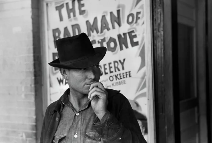 Framed Print : Man in front of a movie theater playing THE BAD MAN OF BRIMSTONE, Waco, Texas, photograph by Lee Russell, 1939 Framed Print : Man in front of a movie theater playing THE BAD MAN OF BRIMSTONE, Waco, Texas, photograph by Lee Russell, 1939