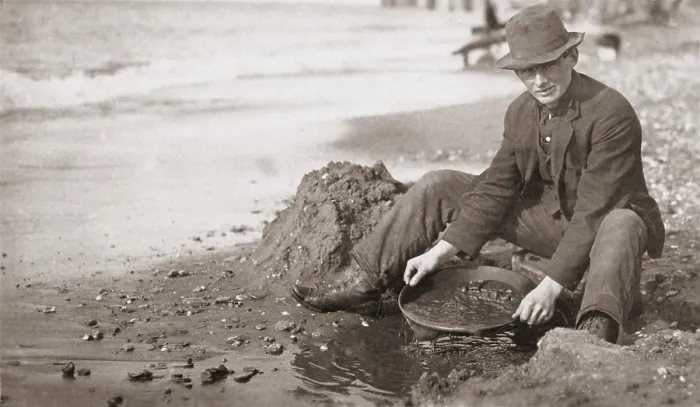 Framed Print : Man panning gold on Nome, Alaska, Beach in the early 20th century