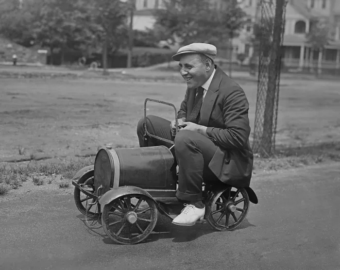 Framed Print : Man seated on a child's toy car in a street. New York City vicinity, 1920s (BSLOC_2016_10_133)