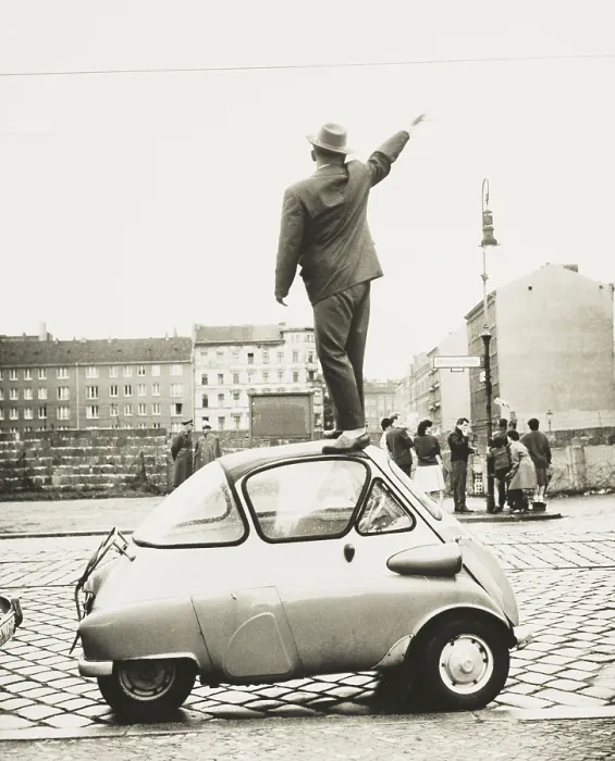 Framed Print : A man standing on top of a small three-wheeled car waving across the newly constructed Berlin Wall. This West Berliner waves to East Berliners on Sept Framed Print : A man standing on top of a small three-wheeled car waving across the newly constructed Berlin Wall. This West Berliner waves to East Berliners on Sept