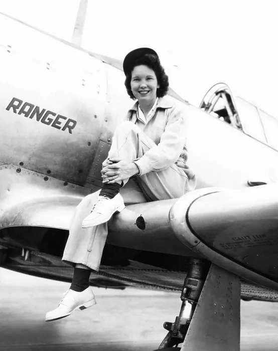Framed Print : Margaret (Mickey) McGrath, former WASP sitting on the wing of in an XAT-6E trainer aircraft. It was equipped with an experimental Ranger Engine