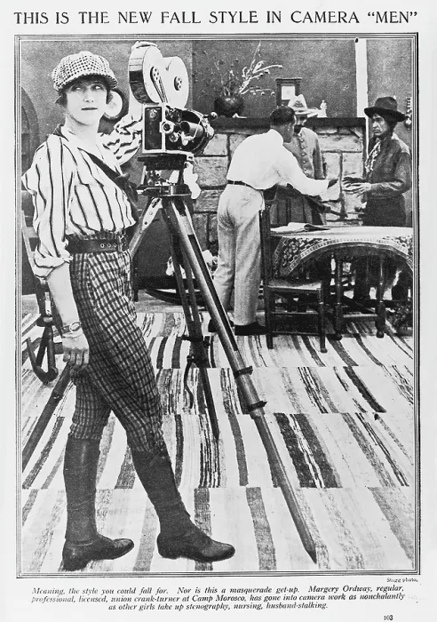 Framed Print : Margery Ordway, woman cinematographer, text reads This is the new Fall style in camera men, Meaning, the style you could fall for. Nor is this a masquerade get-up