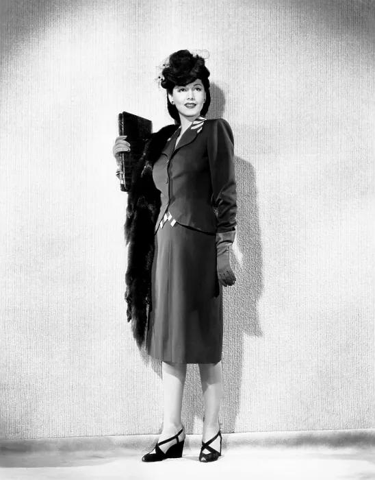 Framed Print : Maria Montez, modeling a brown gabardine suit accented in beige, with a sable hat and scarf, 1943