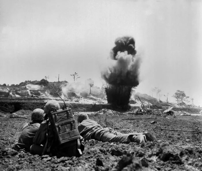 Framed Print : Marine demolition crew watch dynamite charges explode and destroy a Japanese cave. 6th Marine Division, May 1945. World War 2. (BSLOC_2013_13_93)