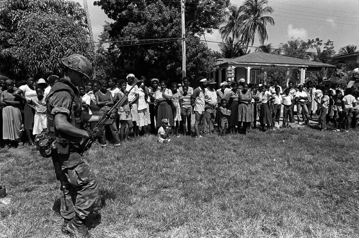 Framed Print : Marine guards civilians after his battalion landed on Grenada during the U.S. invasion. Oct 25-Nov 3 1983. (BSLOC_2011_3_25)