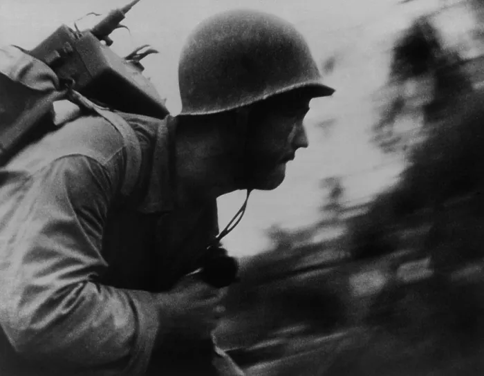 Framed Print : A Marine runs across the beach on Peleliu Island, Sept. 1944