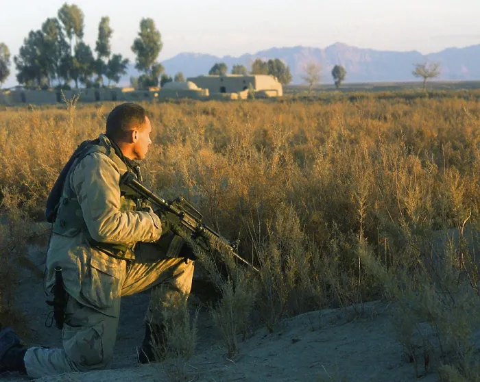 Framed Print : Marine Scout armed with M4 Carbine rifle provides security at a roadside south of Kandahar City during a patrol Framed Print : Marine Scout armed with M4 Carbine rifle provides security at a roadside south of Kandahar City during a patrol