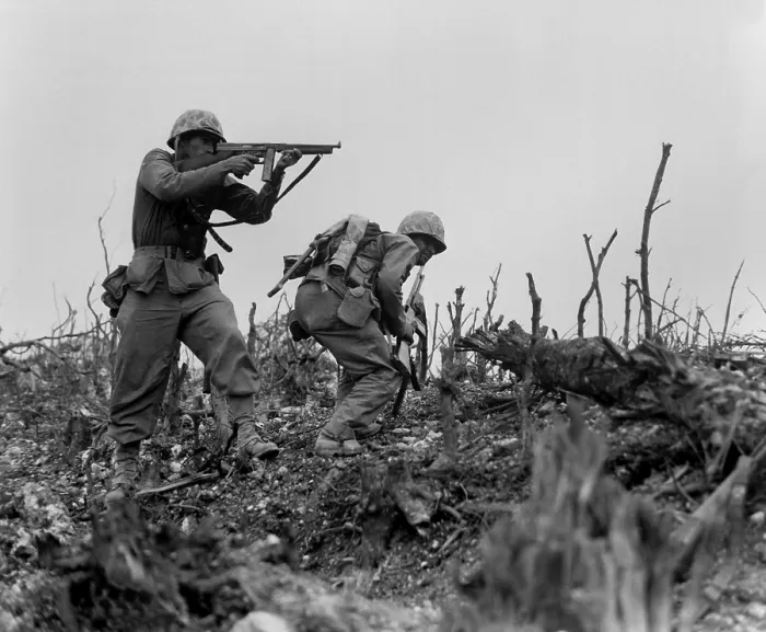Framed Print : Marine sights his tommy gun on a Japanese sniper, as his companion ducks for cover. With the 1st Marines, they are engaged in taking Wana Ridge before the town of Shuri, Okinawa