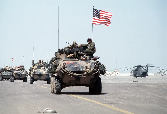 Framed Print : US Marines roll into Kuwait International Airport in light armored vehicles after the retreat of Iraqi forces during Operation Desert Storm. Feb. 27 1991. (BSLOC_2011_12_5)