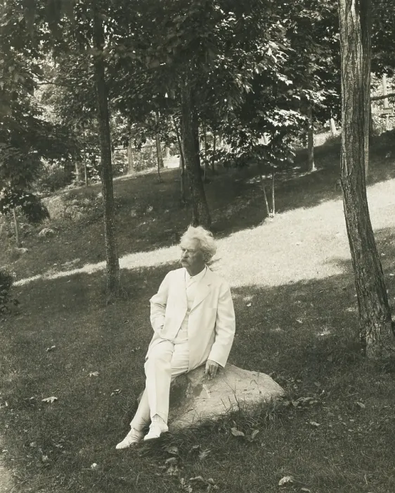 Framed Print : Mark Twain (aka Samuel Clemens), seated on a rock in a park. 1905-1910 (BSLOC_2016_11_136)