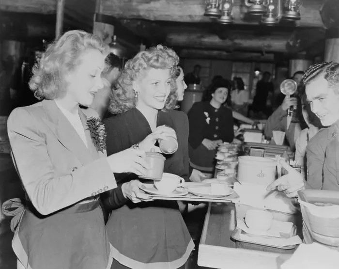 Framed Print : Marlene Dietrich and Rita Hayworth serve soldiers at the Hollywood Canteen during World War 2. Nov. 17, 1942. - (BSLOC_2014_17_76)
