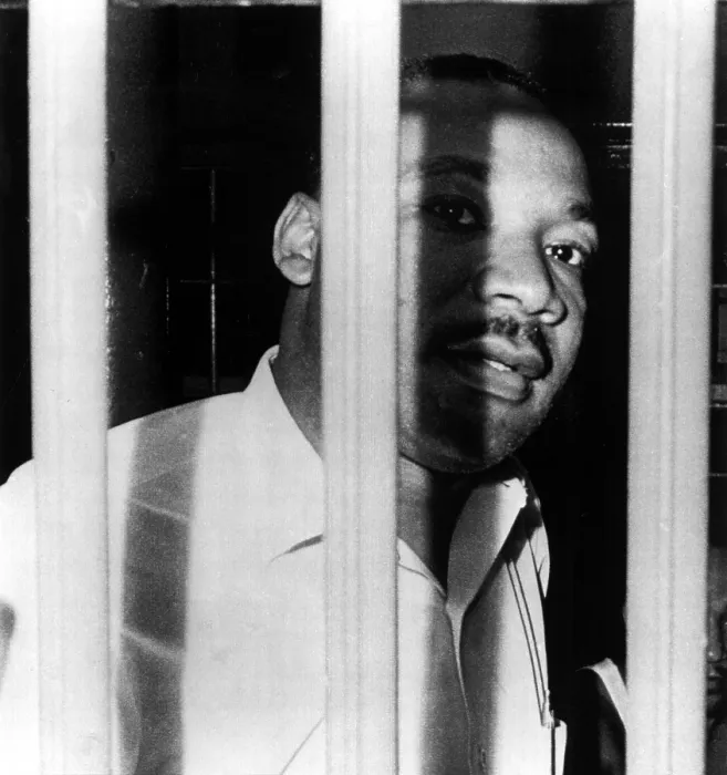 Framed Print : MARTIN LUTHER KING, JR, peers between the bars of his jail cell in the St. John's County Jail, Florida