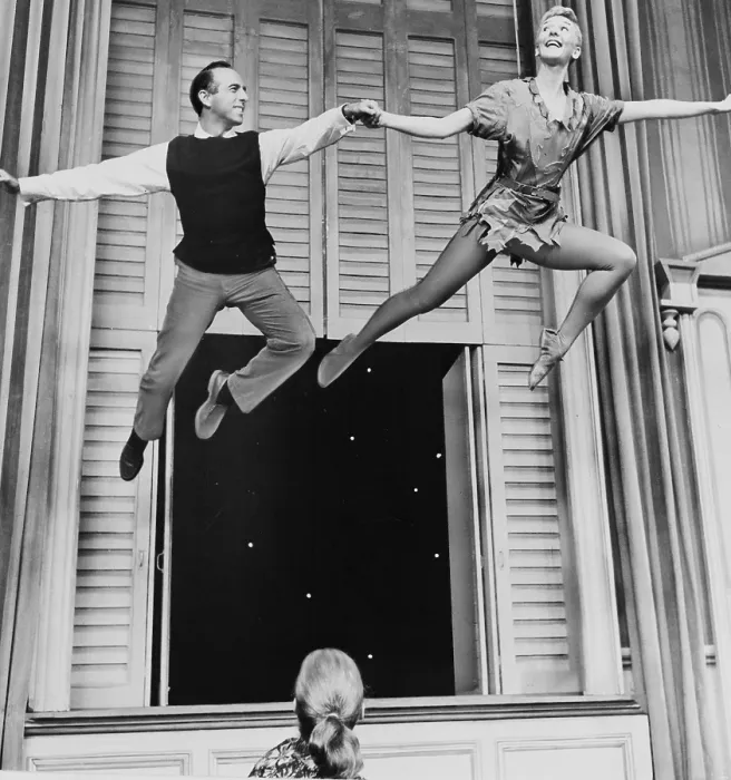 Framed Print : Mary Martin (1913-1990) and Director Jerome Robbins (1918-1998), flying onstage in rehearsal for a 1956 PETER PAN Television production Framed Print : Mary Martin (1913-1990) and Director Jerome Robbins (1918-1998), flying onstage in rehearsal for a 1956 PETER PAN Television production